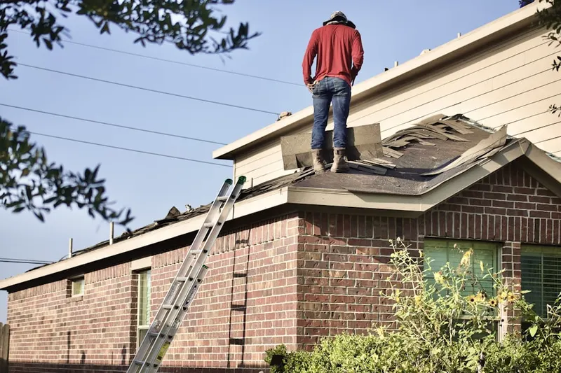 Professional roofer working on a residential roof in Harris Acres
